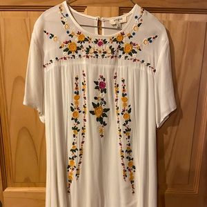 Short sleeved, white, floral-embroidered boutique dress, size small.